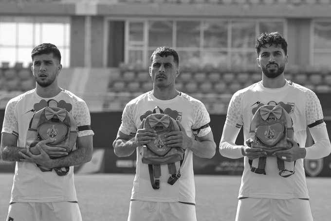 Backpacks and black armbands: Iran footballers honor victims of deadly elementary school strike